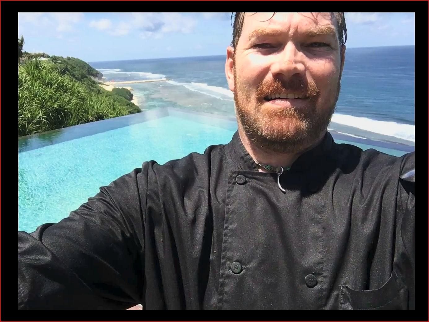 Mark in chef whites by an infinity pool